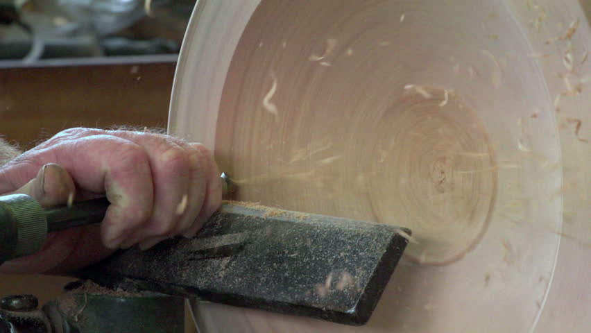 Dargaville, New Zealand. May 2013. Filmed slow motion close up of wood carver creating a timber bowl from swamp kauri