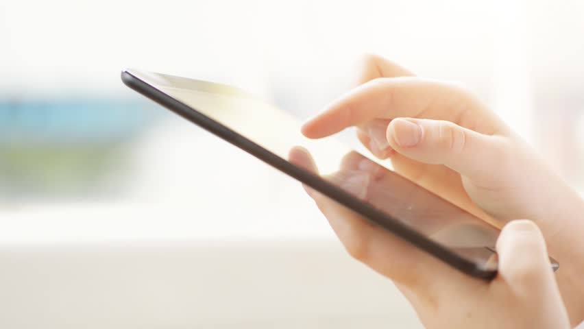 hand touching tablet computer surface touchscreen ipad