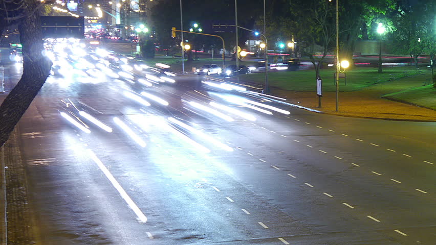 Traffic in the city. Avenue Time-Lapse, Night. Heavy traffic / jam / flowing with blurred motion. Dusk. Dolly out / zoom.