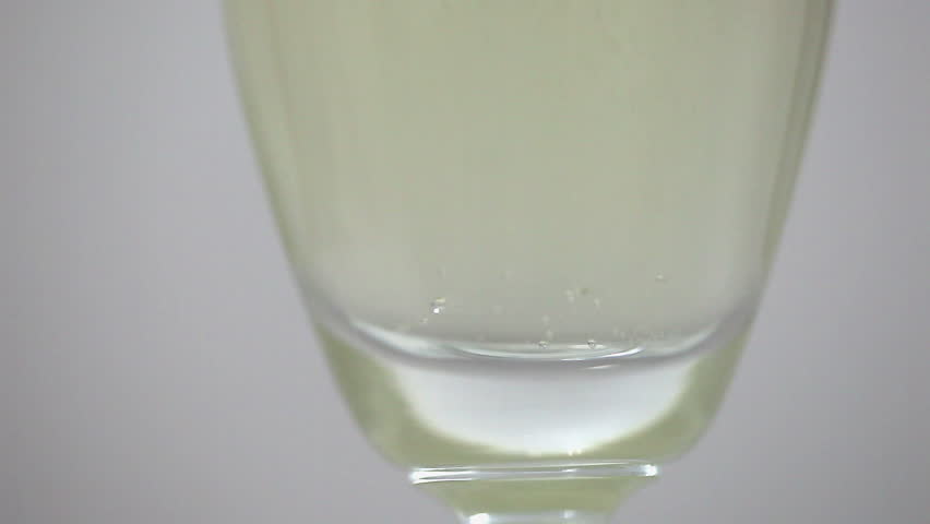Closeup sparkling wine with bubbles in a glass