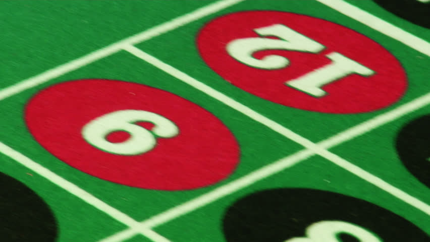 Swish pan of chips on a roulette table