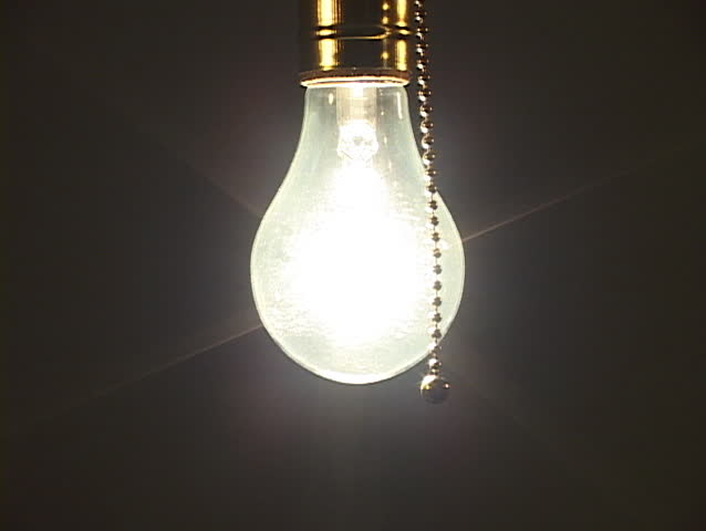 Close up of tungsten light bulb being turned off to with soft ambient light remaining