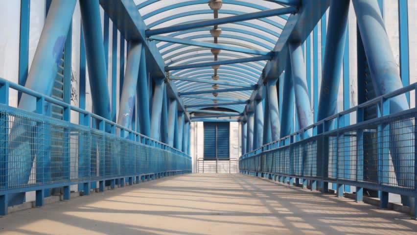 Boy strides on bridge 