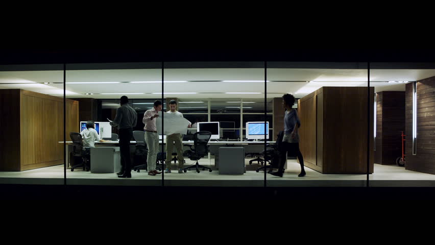 Contemporary small creative business working late through the night.  Casual young people in architecture company.