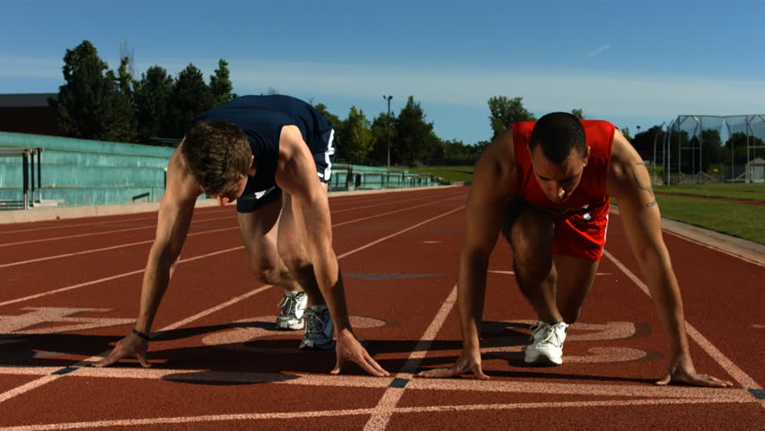 Track runners at starting line, slow motion