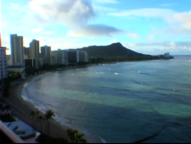 Time lapse of sunrise at Waikiki beach scene with Diamond Head in the background.