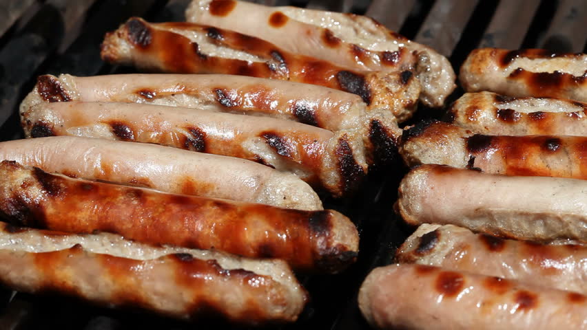 Sizzling sausages on a bbq grill