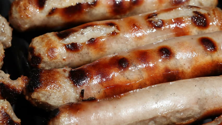 Sizzling sausages on a bbq grill