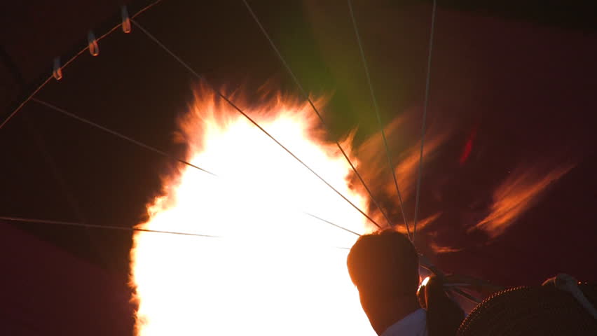 A hot air balloon gets inflated by propane gas.
