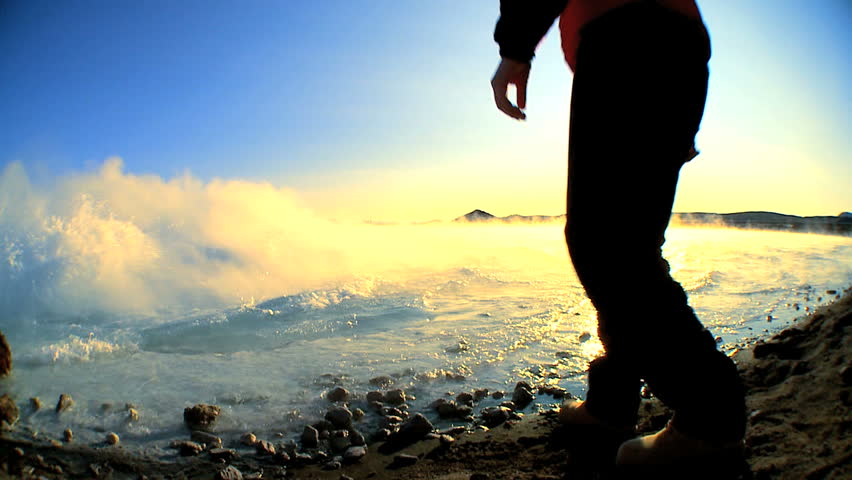 Geologist studying the ground by water heated by geothermal hot springs 60 FPS