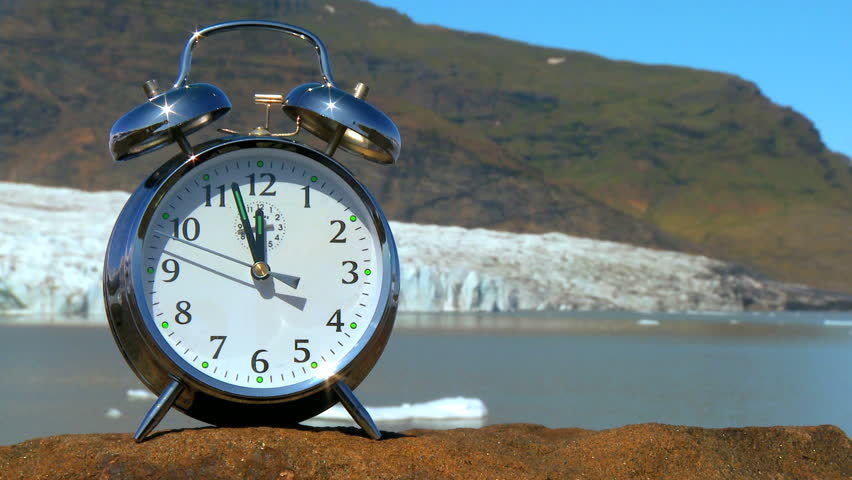 Concept shot of the hands on a clock moving  as time to prevent climate change runs out (real time)