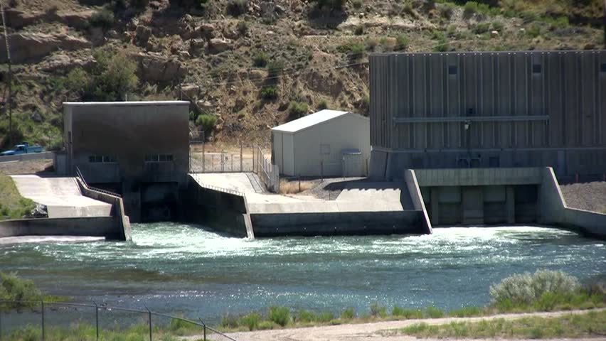 HD clip of water coming out of the spillways of Navajo Lake in northern New Mexico, zooming out to a wider view of the dam
