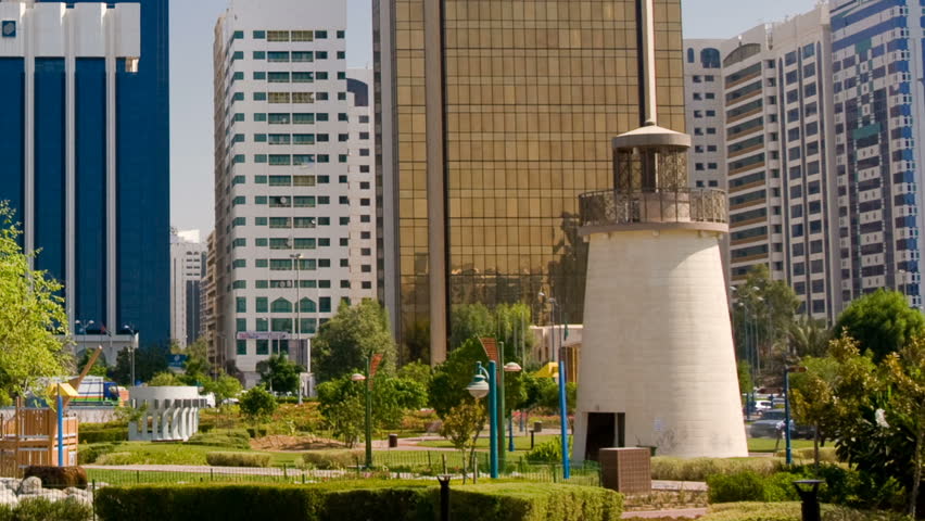 Pan out from a lighthouse in Abu Dhabi to a skyline of modern skyscrapers
