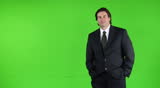 Happy dynamic business man standing off-center - green screen