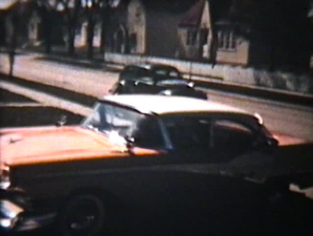 A variety of old cars backing out of a driveway in suburbia - Vintage 8mm film footage from 1960.