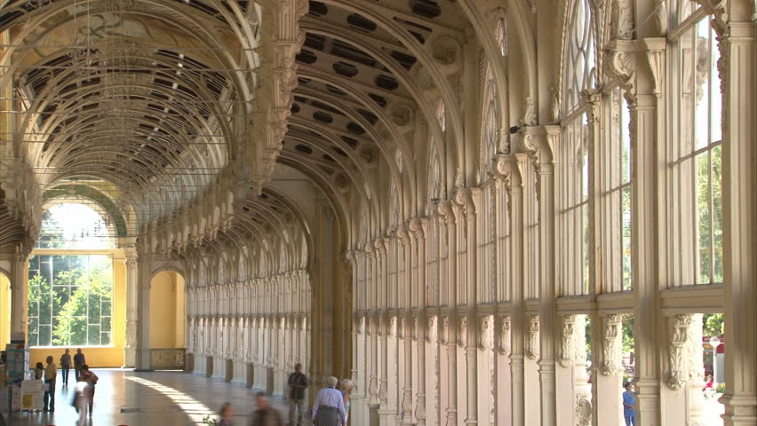 People are walking in pseudo-baroque cast iron unique City Colonnade in Marianske Lazne (West Bohemia, Czech). Time lapse.