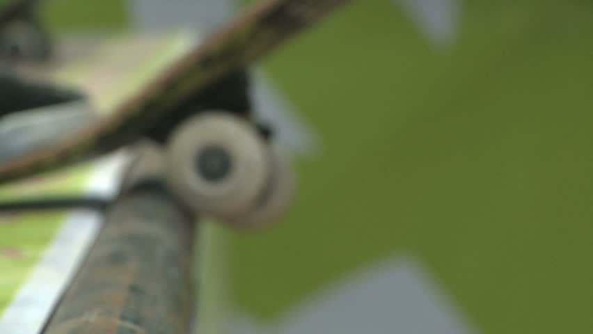 This is a slow motion (60fps) close up shot of a skateboard dropping into a ramp