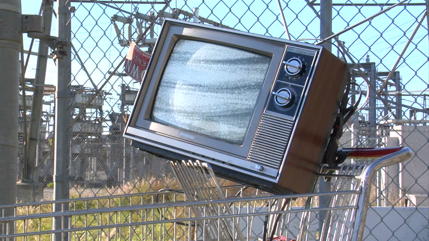 This is a unique shot of a retro tv in a shopping cart in front of a power station. Great design possibilities if you matte out the static. Play video on your website, dvd menu, or as a tv show bumper