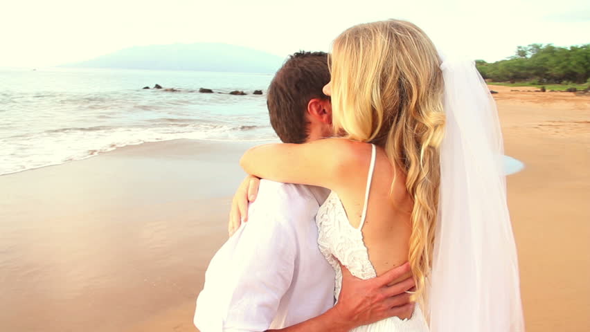 Newly Married Couple Kissing On Tropical Beach After Sunset Wedding Romantic Bride And Groom