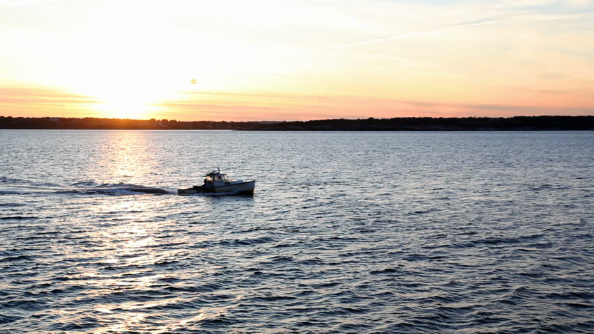 Beautiful 1080 high definition sunset over water with boat