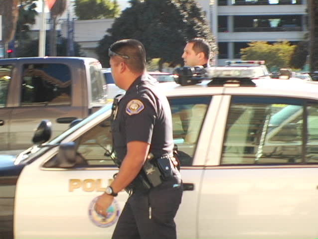 Two officers arrive at the scene of a police shooting.