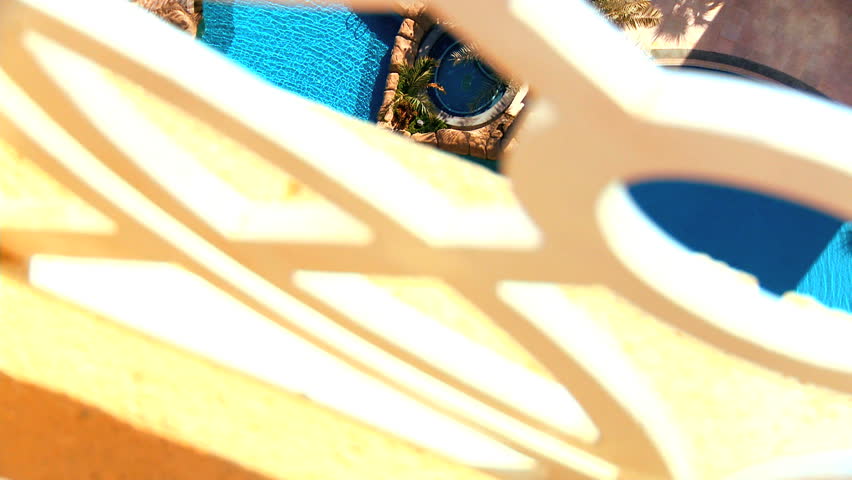 View of inviting swimming pools from balcony of a luxury apartment