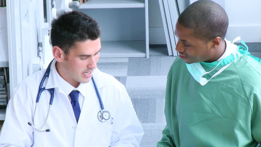 Footage of surgeon and doctor speaking in hospital hall in high definition