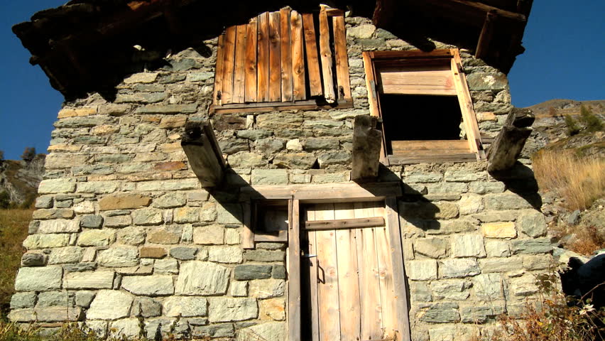 Stone barn in alpine meadow in fall with the Matterhorn, Switzerland - motion-jib