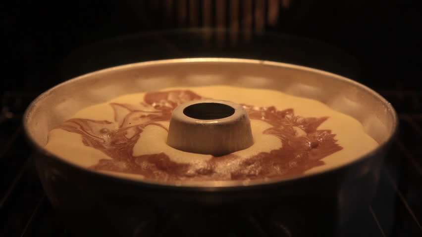 Time lapse of a sweet and tasty marble cake rising in the oven
