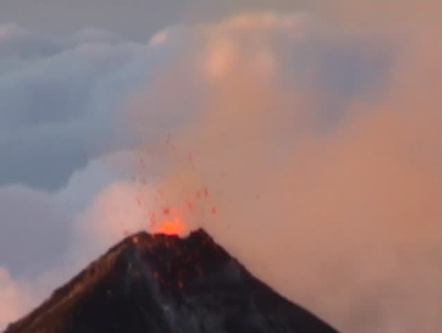 Volcano fuego in Guatemala with an eruption  at sunset