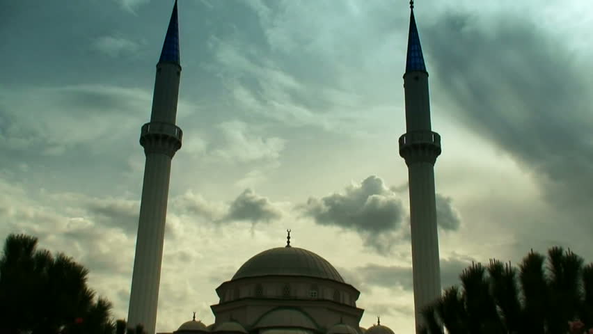 Time lapse clouds flowing past  twin minaret mosque 5