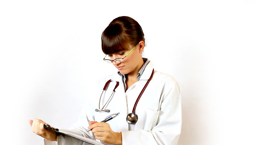Female doctor in glasses recording something on notepad