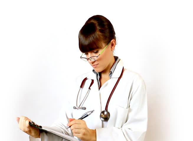 Female doctor in glasses recording something on notepad