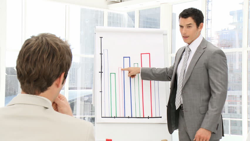 Elegant business man presenting statistics in the office