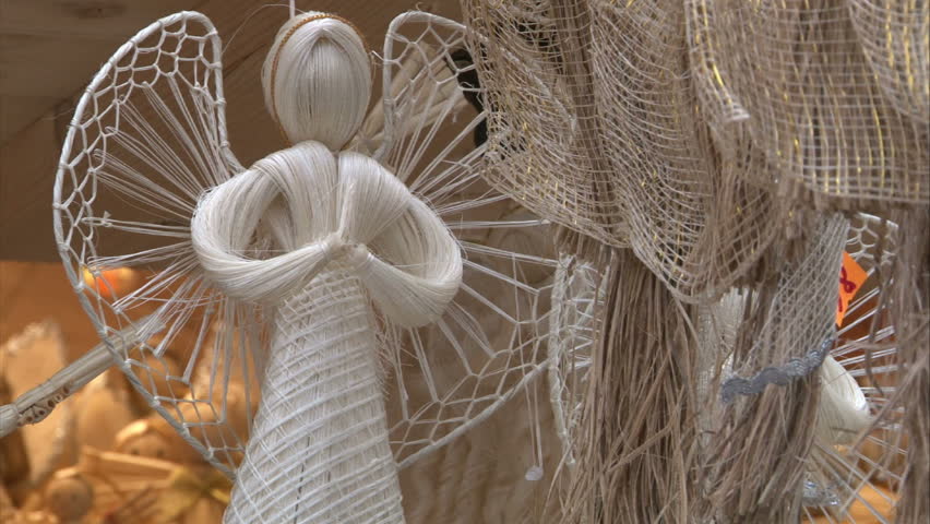 Angels on sale. Handmade decoration. Traditional Czech christmas tree handmade decoration made from bast and straw on christmas market in Prague. Loop ready.