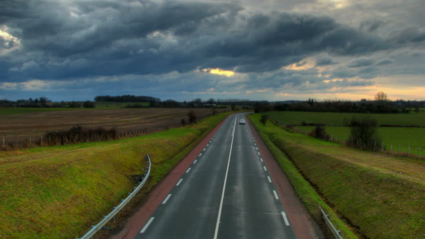 Sunset over highway car lights, HD time lapse clip, high dynamic range imaging
