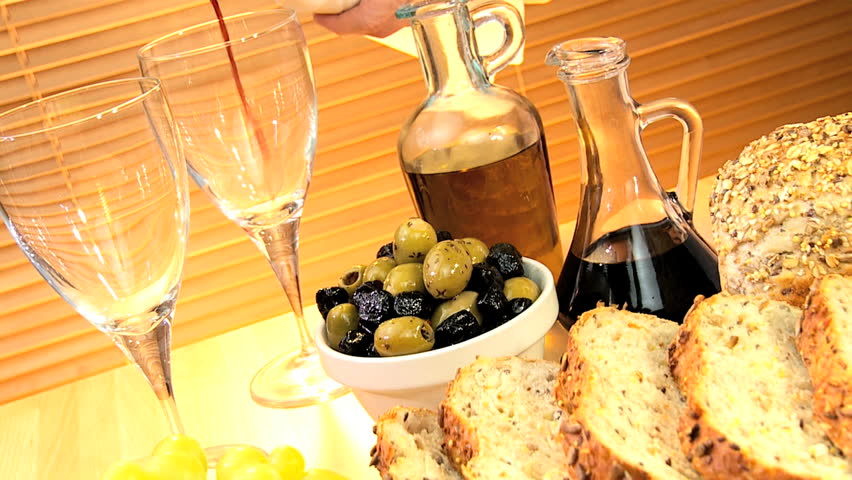Delicious selection of cheeses, whole-grain bread, olive oil & fruit served with white wine for a healthy modern lifestyle lunch