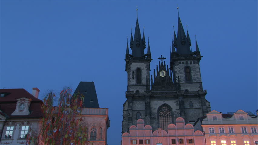 Lighting up of St. Teyn gothic cathedral on Old Town Square in Prague. Time lapse. 