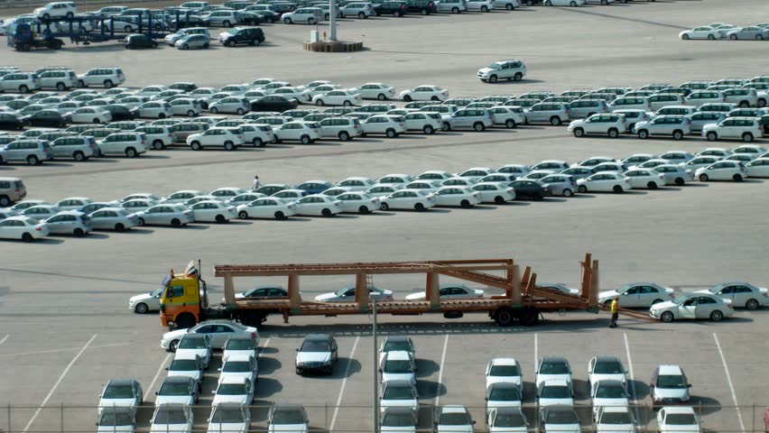 Parking of cars, loading of cars on a lorry, on sunny day. Time lapse. 