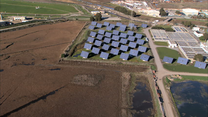 Aerial view of solar energy panels & production plant on industrial land 