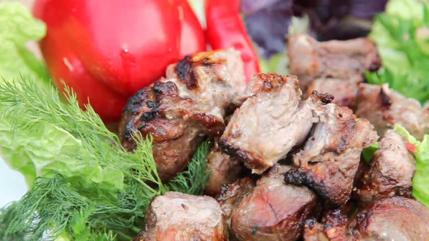 Grilled meat with vegetable on rotating table