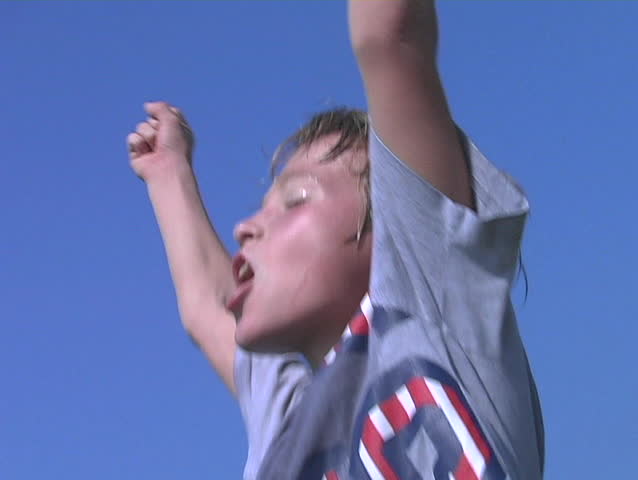 Young boy kicks a soccer ball then jumps and cheers