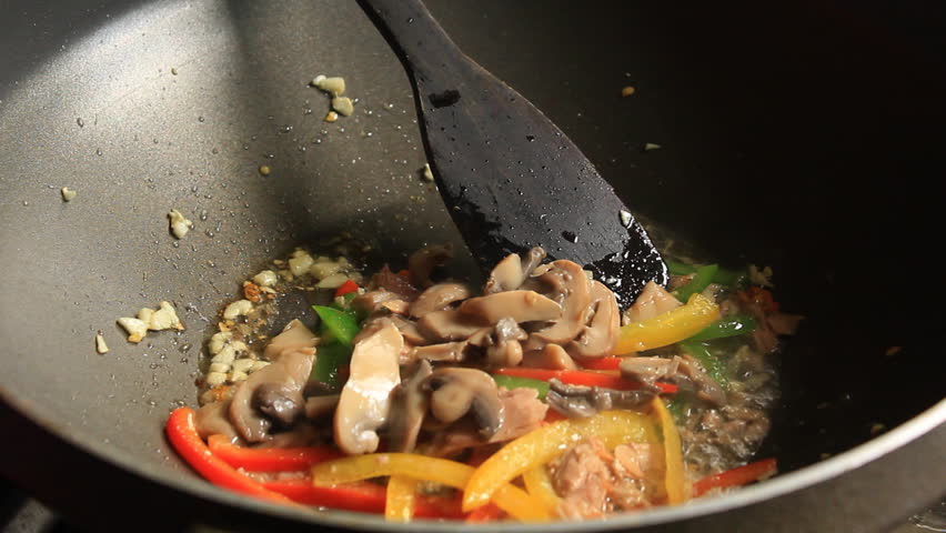 Tossing Fettuccine Into The Pan A chef drops fettuccine into the pan.