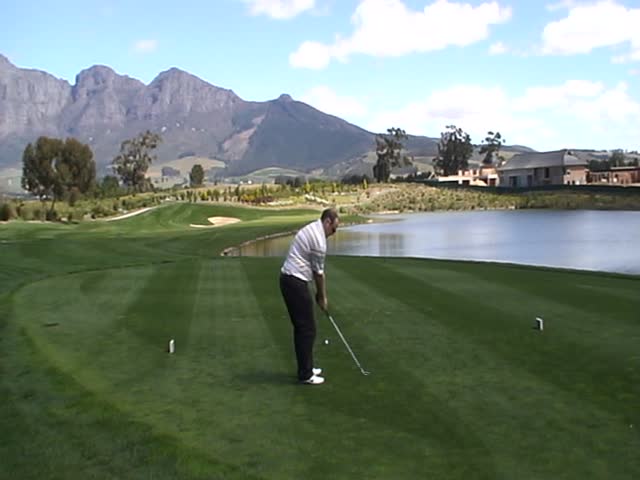 Golfer teeing off on a sunny day