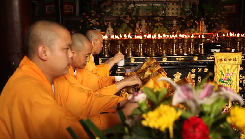 LESHAN, CHINA - AUGUST 24: Buddhist monks performing ceremony inside Baoguo monastery, Leshan, Sichuan, China, August 24, 2009