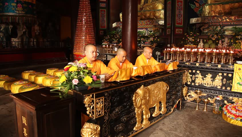 LESHAN, CHINA - AUGUST 24: Buddhist monks performing ceremony inside Baoguo monastery, Leshan, Sichuan, China, August 24, 2009