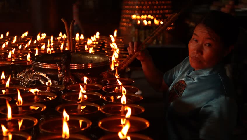 LESHAN, CHINA - AUGUST 24: Buddhist performing ceremony inside Baoguo monastery, Leshan, Sichuan, China, August 24, 2009