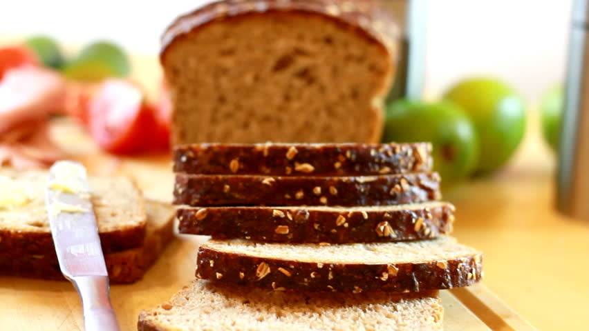 Slices whole grain bread, ham and vegetables, pan shot - 1080p
