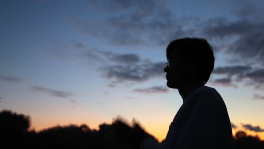 ÃâÃÂlose up person prayerfully putting hands against wood at dawn 