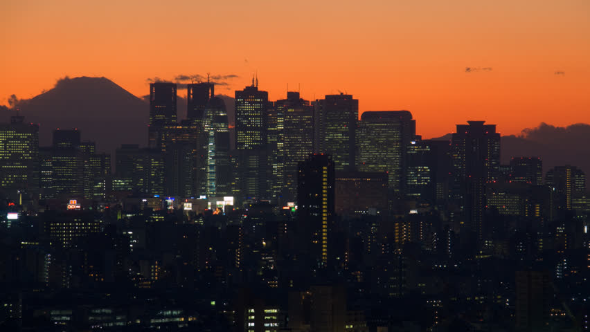 Traffic streaks through-out frame in wide shot of Tokyo, Japan, time-lapse